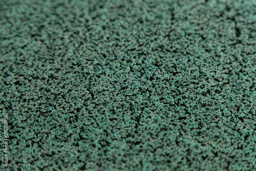 Green textured surface made from small particles in workshop setting