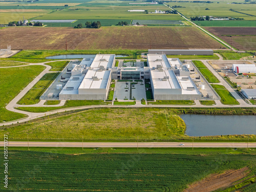 Aerial view of huge data center facility with rooftop cooling units and surrounding industrial infrastructure in DeKalb, Illinois