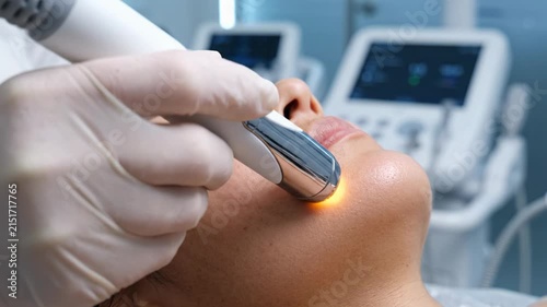 Advanced facial treatment rejuvenation equipment technology for woman beauty cosmetic procedure dermatology clinic skin care offering relaxation and gentle warmth close up of woman pampered
