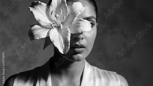 Captivating Portrait Woman, Flower Obscures Eye, Mystery, Vulnerability, Subtle Emotion, Contemplation, Black and White Impactful Visual, Unveiling Delicate Beauty, Thoughtful Serenity, Expressive