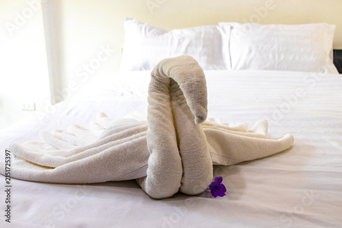 Towel Swan With Tropical Flower On Hotel Bed In Thai Hotel Room.