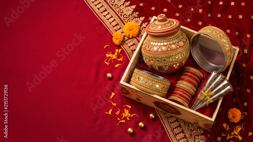 Traditional Karwa Chauth puja thali with decorated pot, bangles and festive red textile for Indian fasting ritual and cultural celebration