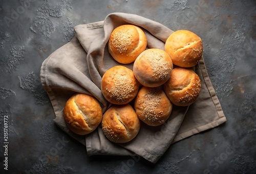 Freshly Baked Sesame Seed Buns Arranged on a Neutral Fabric Napkin Top View bread