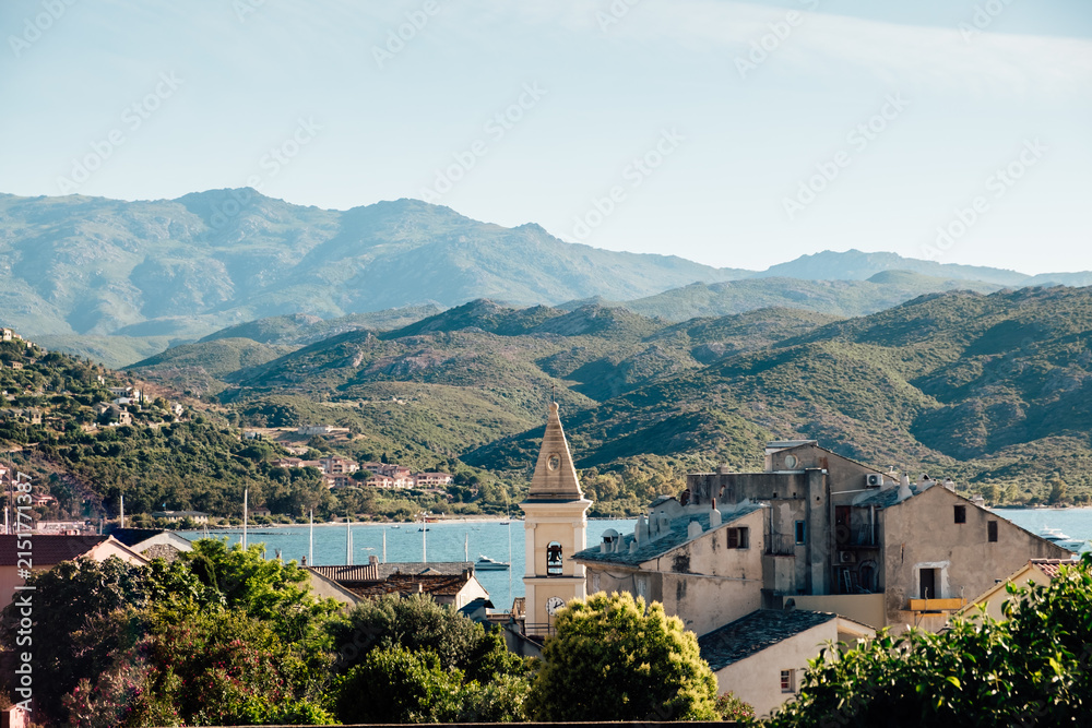 Obraz premium View of the montains over the roofs of Saint-Florent in Corsica