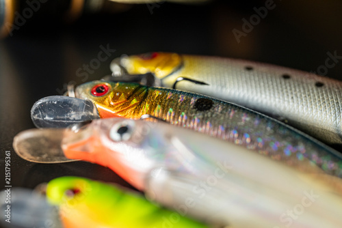 Obraz na plátne Row of plastic wobbler lures on black background The Concept of predator fishing