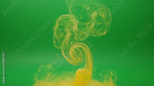 Golden Ink Swirls Expanding in Water Against Green Background Seamlessly Abstract
