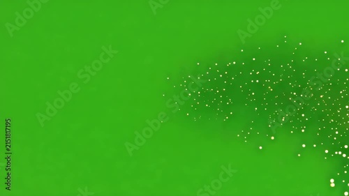 Golden glowing particles swirling in cinematic motion against a vibrant green screen background