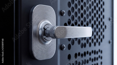 Foto Modern silver handle on a textured black server rack door with ventilation holes