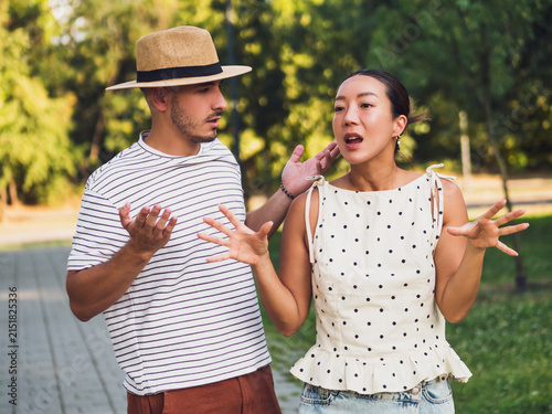Canvastavla Emotional couple having a heated disagreement while standing on a pathway surrounded by green trees