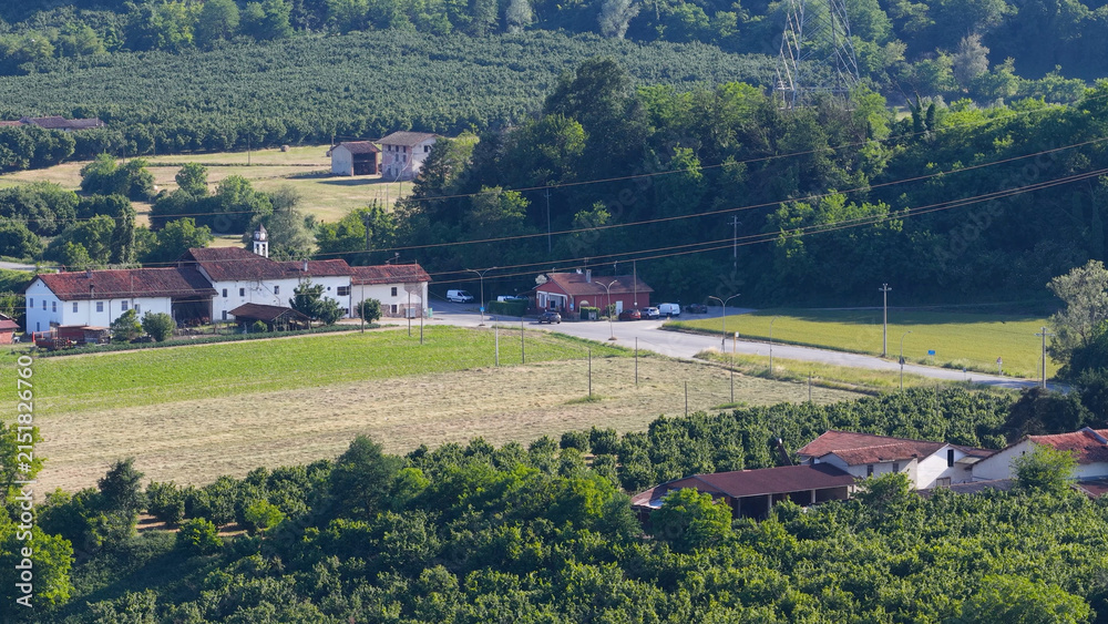 Obraz premium Aerial View of Traditional Farmhouse and Agricultural Fields in Piedmont Italy
