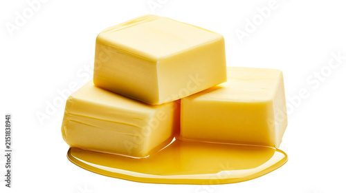 Cuadro en lienzo Three butter cubes melting in golden liquid
