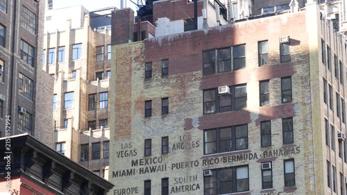 New York City Midtown urban residential building, red brown brick architecture, Manhattan rooftop, United States of America. Water tower on roof. Classic water tanks. Hells Kitchen Port Authority area