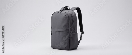 Modern minimalist gray backpack with multiple compartments designed for everyday use with set against plain light background background emphasizing functional