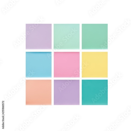 Pastel sticky notes arranged in a grid, colorful paper memo pads on white background, minimalist office stationery for planning and organization