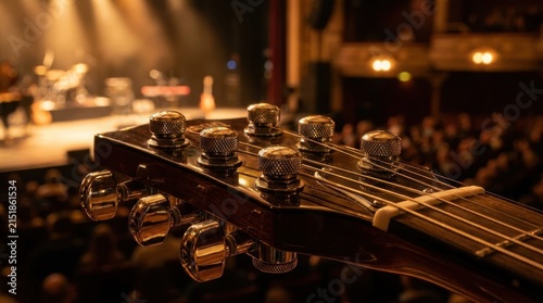 Close-up view of gleaming chrome guitar tuning pegs with fine knurl on a musical instrument headstock during a live performance