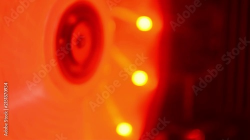 Spinning computer cooling fan with red led illumination. Hardware component rotating inside gaming system. Modern electronic equipment for pc heat dissipation process.