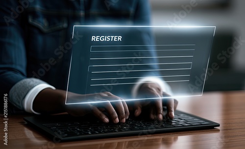 Person typing on a keyboard, interacting with a digital registration interface