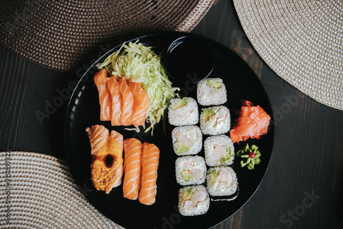 Fotografía Assorted sushi platter featuring salmon sashimi, rolls, pickled ginger, and wasa