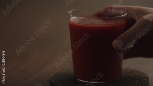 Slow motion man hand take tomato juice in a glass