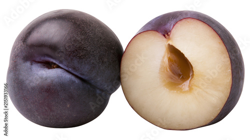Whole and halved dark purple plum fruit
