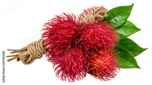 Bunch of red rambutan fruits tied with jute rope and green leaves