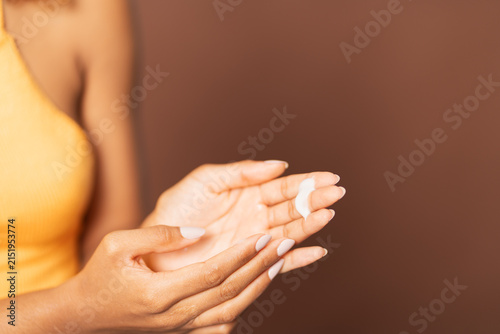 Obraz na plátne Woman applying hand cream for skin care routine