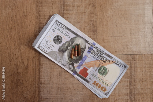 Canvastavla High Angle of Metal Rifle Bullets on Stack of Dollar Bills