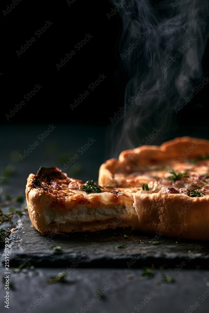 Fototapeta premium Goat Cheese Tart with Dramatic Steam and Thyme on Black Slate