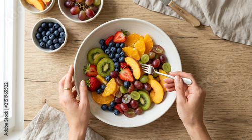 Fresh Mixed Fruit Salad Bowl for Healthy Breakfast or Snack. Vibrant Berries, Kiwi, Orange, Peach, Grapes, Clean Eating