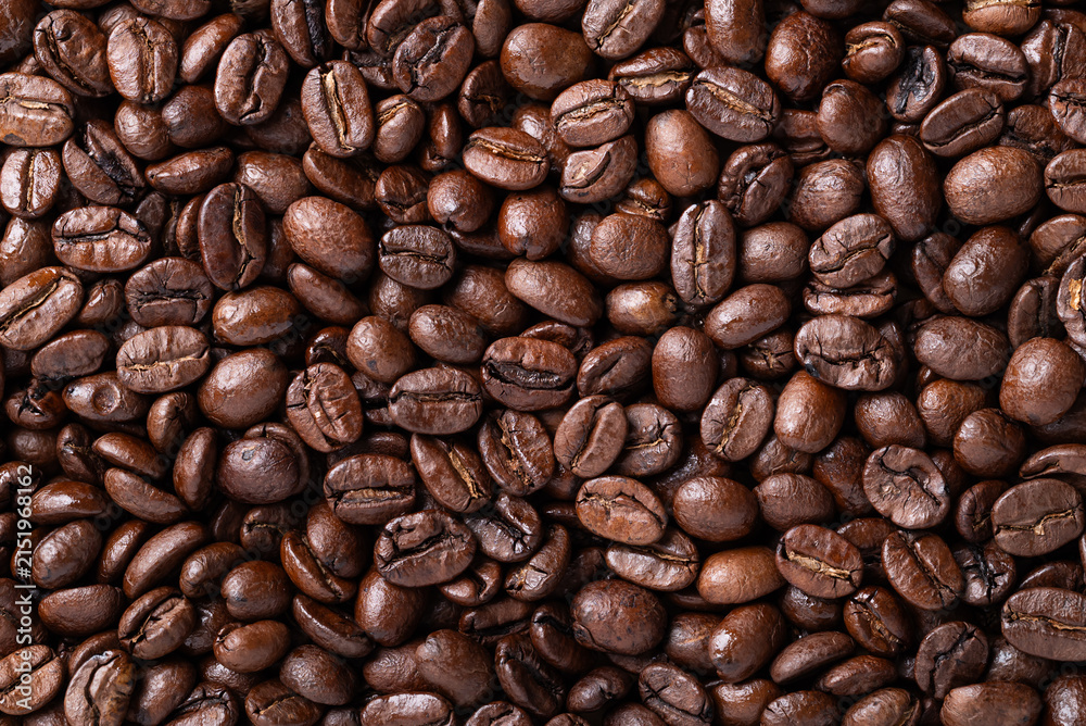 Fototapeta premium Close-up of medium dark roasted coffee bean texture background, Arabica coffee