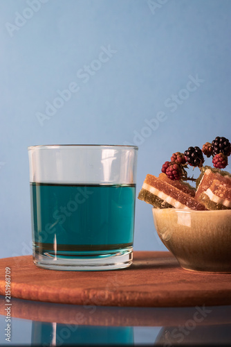Bild auf Leinwand Close up of a bowl with jelly candies and blue tea (butterfly pea flower tea)