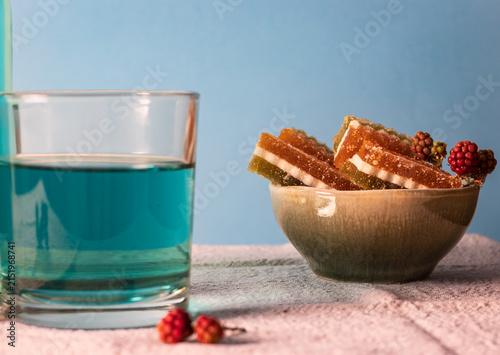 Принти на полотні Close up of a bowl with jelly candies and blue tea (butterfly pea flower tea)