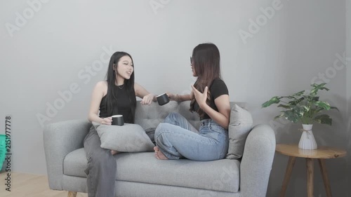 Two Asian Women Having a Casual Conversation Over Coffee at Home