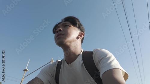 Young Asian Man Cycling Through Yogyakarta, Low Angle View