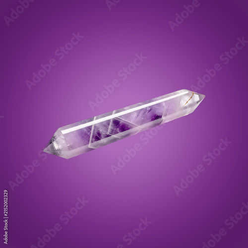 Transparent glass perfume bottle with purple liquid and cap on purple background
