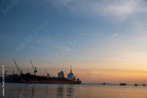 Cuadro en lienzo Industry landscape on sunset Engineering shipping crane depot at logistic export terminal control