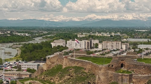 Aerial View of Gori Fortress with Georgian Flag and Caucasus Mountains