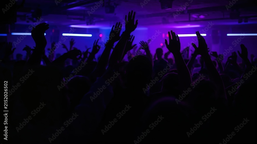 Fototapeta premium Crowd of people dancing at night club with hands in air. Young man and woman silhouettes enjoying music at live concert. Entertainment, rave party, night life and social event concept.