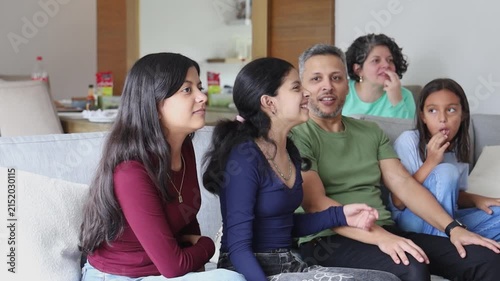 Family Bonding Together While Watching Television on Sunday