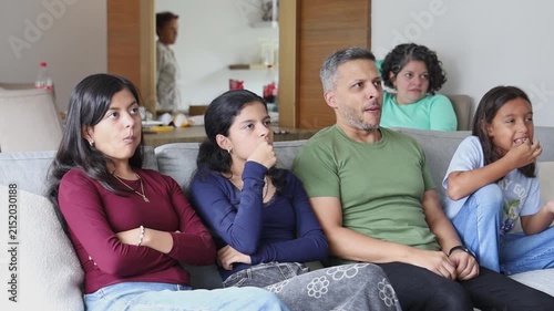 Multigenerational Family Sitting Together Watching Television at Home