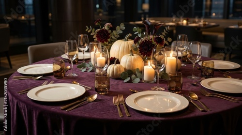 Elegant dinner table setting with pumpkins and candles for autumn event