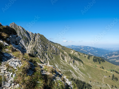 Rugged alpine ridge and green pastures in Bernese Oberland - panoramic mountain landscape in Switzerland