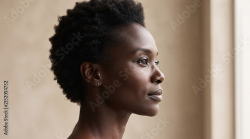 Portrait of a beautiful African American woman with short natural hair looking away.