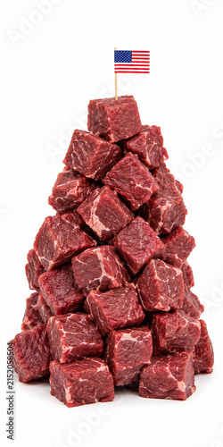 Raw beef cubes stacked in a tall tower with small American flag