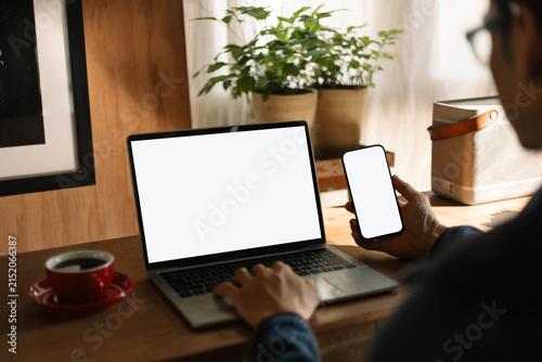 computer screen,mobile phone blank mockup.work using laptop texting cell phone.white background for advertising,contact business search information on desk.marketing,design