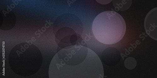 Abstract bokeh circles and light effects in dark moody background.