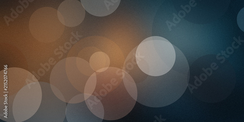 Abstract bokeh circles on textured background with warm and cool color blend.