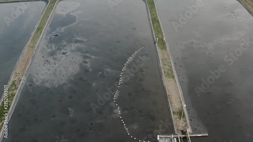 Sewage treatment lagoon and wastewater basin with sludge aeration, sanitation management and pollution, aerial view.