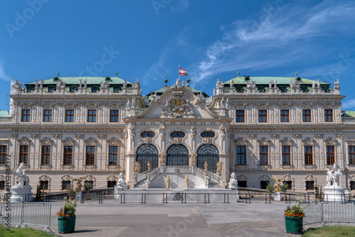 Symmetrical front facade of historic Upper Belvedere palace under blue sky in Vienna