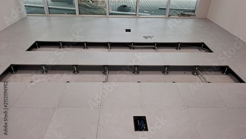 Raised access floor installation with exposed underfloor space and cable outlets in a data center